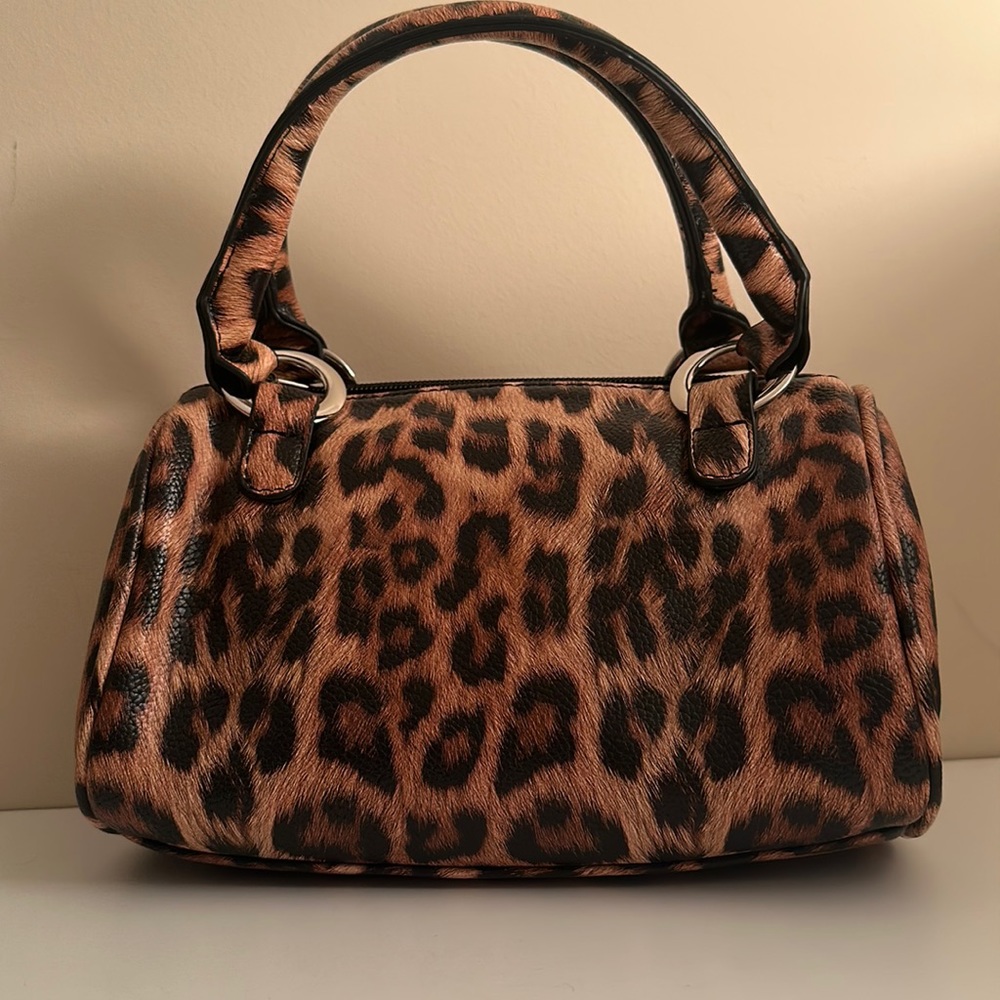 Adorable animal print leather handbag with coin purse and dust bag.